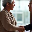 Two diverse wellness professionals shaking hands, implying partnership and collaboration.